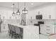 This modern kitchen has white cabinets, marble countertops, and a large island with barstool seating at 7633 Marietta St, Orlando, FL 32807