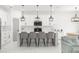 Modern kitchen with stainless steel appliances, island with seating, and stylish pendant lighting at 7633 Marietta St, Orlando, FL 32807