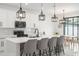 Modern kitchen with stainless steel appliances, island with seating, and stylish pendant lighting at 7633 Marietta St, Orlando, FL 32807