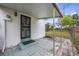 A covered back porch area featuring brick pavers, a door with security bars, and a view of the home's expansive backyard at 858 Darwin Dr, Altamonte Springs, FL 32701