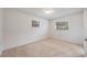 Bright, carpeted bedroom with two windows and neutral-colored walls at 858 Darwin Dr, Altamonte Springs, FL 32701