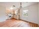 Bright kitchen with light wood-look flooring, clean white cabinets and appliances, and a chandelier enhancing the dining area at 858 Darwin Dr, Altamonte Springs, FL 32701