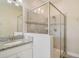 Elegant bathroom featuring a glass-enclosed shower with modern fixtures and a granite-topped vanity at 10012 Lovegrass Ln, Orlando, FL 32832