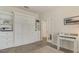 Murphy bed with white cabinets and shelving, complemented by a desk and light-toned floors at 10012 Lovegrass Ln, Orlando, FL 32832