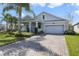 Charming single-Gathering home with a brick-paved driveway, well-manicured lawn, and a two-car garage at 10012 Lovegrass Ln, Orlando, FL 32832