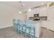 Modern kitchen with granite countertops, pendant lighting, island seating and tiled floors at 10012 Lovegrass Ln, Orlando, FL 32832