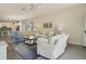 Comfortable living area with neutral tones, plush sofas, and a view into the dining space at 10012 Lovegrass Ln, Orlando, FL 32832