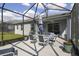 Screened-in patio featuring a dining table and outdoor seating, perfect for entertaining and relaxation at 10012 Lovegrass Ln, Orlando, FL 32832