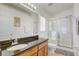 Bathroom features a vanity with dark countertop, a mirror with lighting, a toilet and a glass shower at 1025 Sandy Ridge Dr, Davenport, FL 33896