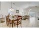 Dining area leading to an open living space filled with neutral-colored furniture and tile flooring at 1025 Sandy Ridge Dr, Davenport, FL 33896