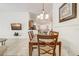 Dining area with a chandelier that flows seamlessly into the kitchen at 1025 Sandy Ridge Dr, Davenport, FL 33896