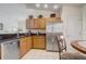 Stainless steel appliances, wood cabinets and granite counters in this well-equipped kitchen at 1025 Sandy Ridge Dr, Davenport, FL 33896