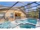 The screened in pool area features a jacuzzi and several seating options at 1025 Sandy Ridge Dr, Davenport, FL 33896