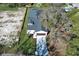 Aerial view of a residential property with a manicured lawn, driveway, and newly installed roof at 1038 Dennis Ave, Orlando, FL 32807