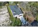 Aerial view of a well-maintained home, showcasing its spacious yard and paved driveway at 1038 Dennis Ave, Orlando, FL 32807