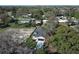 Aerial view of a single-Gathering home in a suburban setting, highlighting mature trees and a nearby cityscape at 1038 Dennis Ave, Orlando, FL 32807