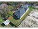 Aerial view of a home with a neatly kept lawn surrounded by mature trees and fencing at 1038 Dennis Ave, Orlando, FL 32807