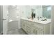 Bathroom boasts double vanity, ample storage, and views of the bedroom at 1038 Dennis Ave, Orlando, FL 32807