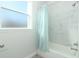 Bathtub and shower combo with blue shower curtain and window at 1038 Dennis Ave, Orlando, FL 32807