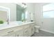 Bright bathroom with double sinks, modern fixtures and a window at 1038 Dennis Ave, Orlando, FL 32807