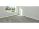 A well-lit bedroom with a large window and neutral carpeting at 1038 Dennis Ave, Orlando, FL 32807