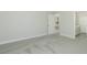 Spacious bedroom with neutral carpet, base trim, and views to other rooms at 1038 Dennis Ave, Orlando, FL 32807