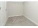 A walk-in closet with door, wire shelving and neutral carpeting at 1038 Dennis Ave, Orlando, FL 32807