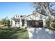 Beautiful single-story home featuring a stone facade, manicured lawn, and a brick driveway at 1038 Dennis Ave, Orlando, FL 32807