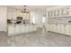 Spacious kitchen boasts tile flooring, shaker cabinets, an island with a sink, and stainless steel appliances at 1038 Dennis Ave, Orlando, FL 32807