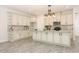 Spacious kitchen featuring custom white cabinets, marble countertops, and stainless steel appliances at 1038 Dennis Ave, Orlando, FL 32807