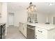 Kitchen island featuring a stainless steel sink, dishwasher, and stylish pendant lighting at 1038 Dennis Ave, Orlando, FL 32807