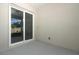 An outdoor patio featuring sliding glass doors and neutral concrete flooring at 1038 Dennis Ave, Orlando, FL 32807