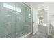 Luxury shower with glass enclosure, pebble floor, and natural light at 1038 Dennis Ave, Orlando, FL 32807