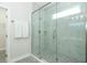 Elegant shower stall with glass door, marble-look tiles, and modern fixtures at 1038 Dennis Ave, Orlando, FL 32807