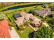 Expansive aerial view of the residence showcasing a screened-in pool, landscaped grounds, and waterfront views at 11234 Willow Gardens Dr, Windermere, FL 34786