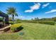 Picturesque backyard with a spacious lawn, mature trees, and hedges, providing privacy and a serene atmosphere at 11234 Willow Gardens Dr, Windermere, FL 34786