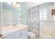 Bright bathroom featuring a blue vanity and a tub with a shower at 11234 Willow Gardens Dr, Windermere, FL 34786