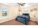 Cozy bedroom featuring a bed, neutral walls, and lots of natural light at 11234 Willow Gardens Dr, Windermere, FL 34786