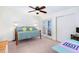 Bright bedroom with a double bed, desk, and access to a balcony at 11234 Willow Gardens Dr, Windermere, FL 34786