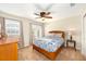 Bedroom with a wooden bed, dresser, and a door to the outside at 11234 Willow Gardens Dr, Windermere, FL 34786