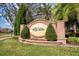 Elegant brick entrance sign for The Willows community, surrounded by lush landscaping and mature trees at 11234 Willow Gardens Dr, Windermere, FL 34786