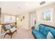 Bright hallway with a wicker couch, chair, and sunny window at 11234 Willow Gardens Dr, Windermere, FL 34786