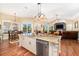 Open eat-in kitchen featuring a large center island, breakfast table and hardwood floors at 11234 Willow Gardens Dr, Windermere, FL 34786