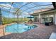 Inviting screened-in pool area with a spa, ample seating, and lush landscaping at 11234 Willow Gardens Dr, Windermere, FL 34786