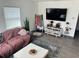 Cozy living room featuring modern decor, a comfortable sofa, and a stylish area rug on wood-look floors at 1218 Depugh St, Altamonte Springs, FL 32701