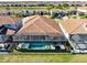 Aerial view of a private residence that features a backyard with a pool, hot tub, and golf course view at 13319 Alderley Dr, Orlando, FL 32832