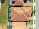 Aerial view of home showcasing an elaborate roof design, screened-in pool, and well-maintained yard in a planned community at 13319 Alderley Dr, Orlando, FL 32832