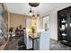 Elegant dining room with modern lighting, gray marble flooring, and sliding glass door at 13319 Alderley Dr, Orlando, FL 32832