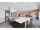 Spacious kitchen features a center island with breakfast bar, pendant lights, and stainless appliances at 13319 Alderley Dr, Orlando, FL 32832