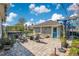 Outdoor space with patio pavers, seating area with hot tub, and a detached garage with a blue door at 13864 Sachs Ave, Orlando, FL 32827